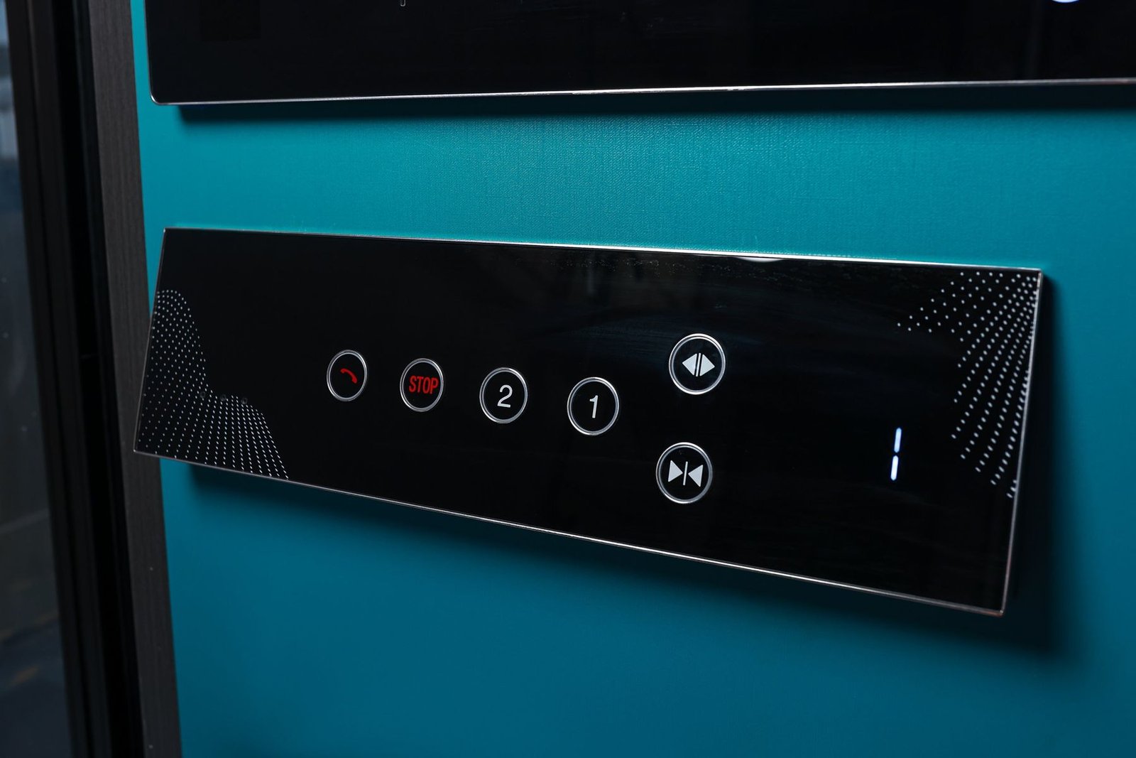 Levitex touch control panel on a dark teal wall.
