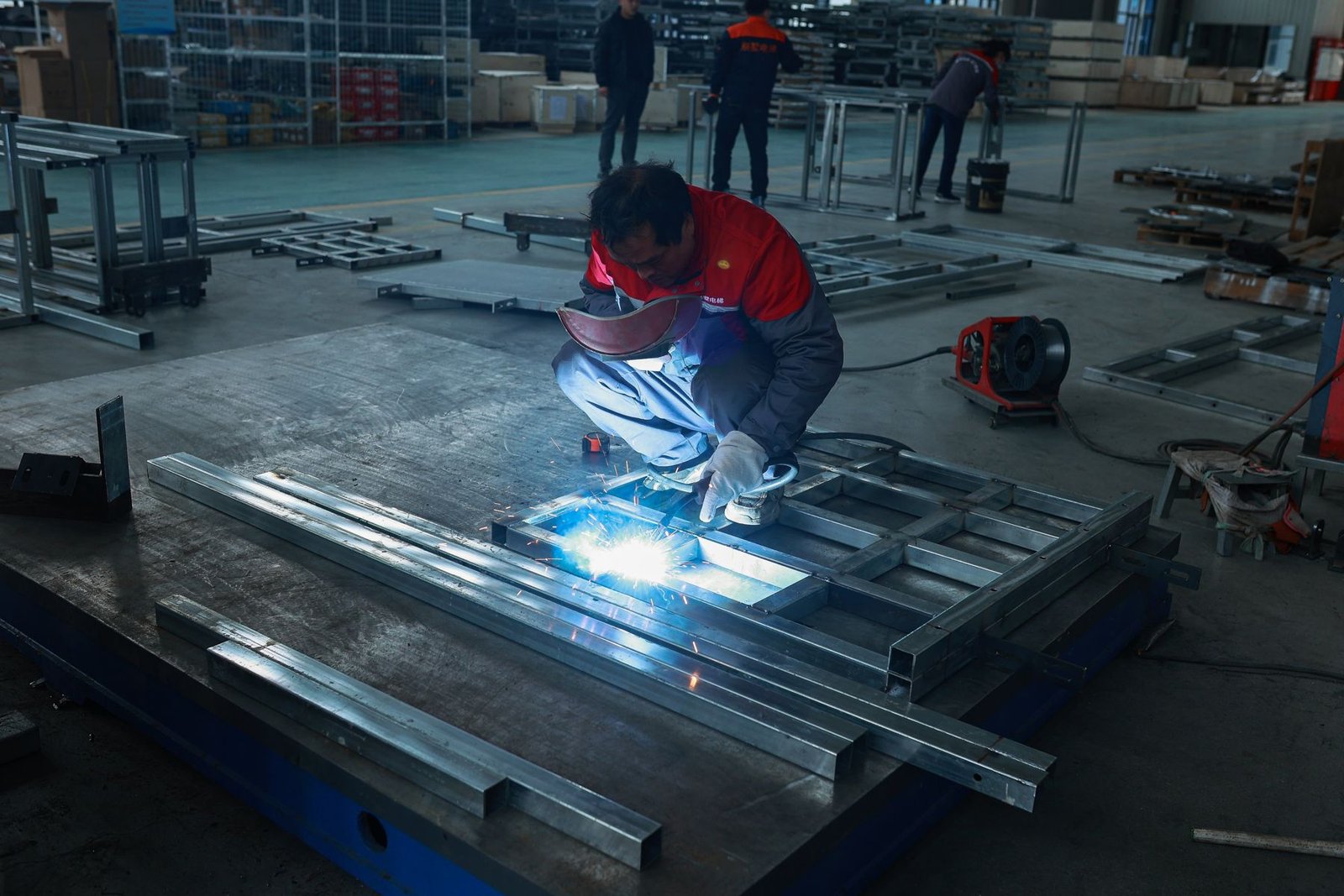 Welder joining a lift frame at the Levitex factory.