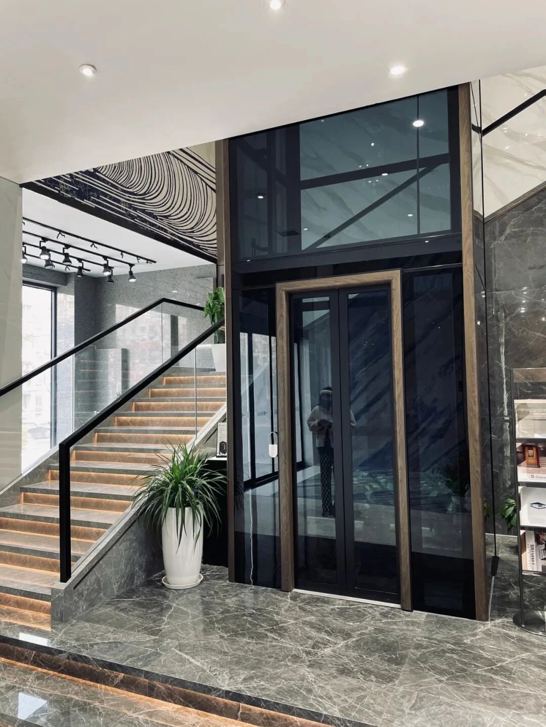 Levitex Max at the foot of a marble staircase.