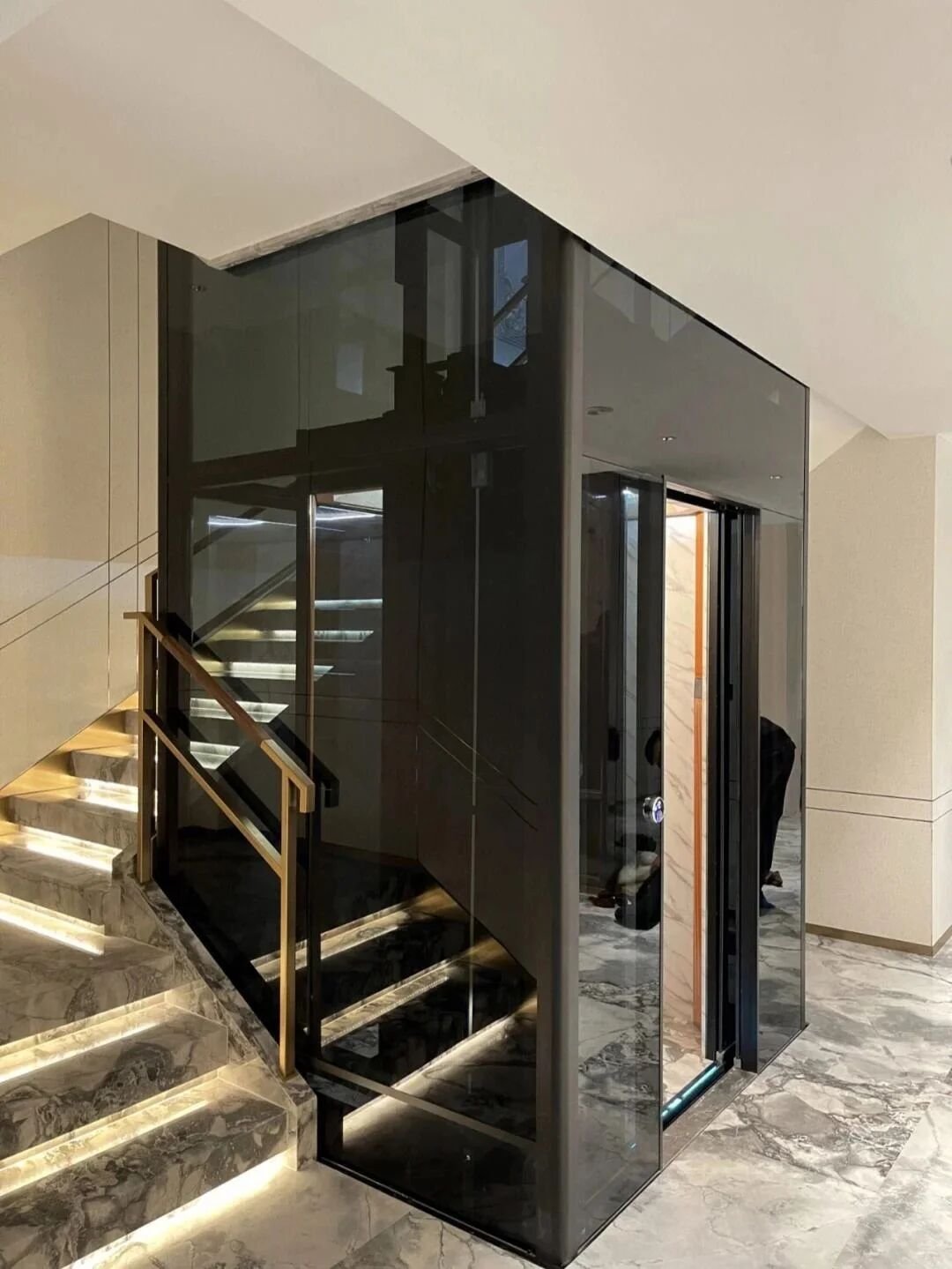 Levitex Max in dark glass beside lit stairs.